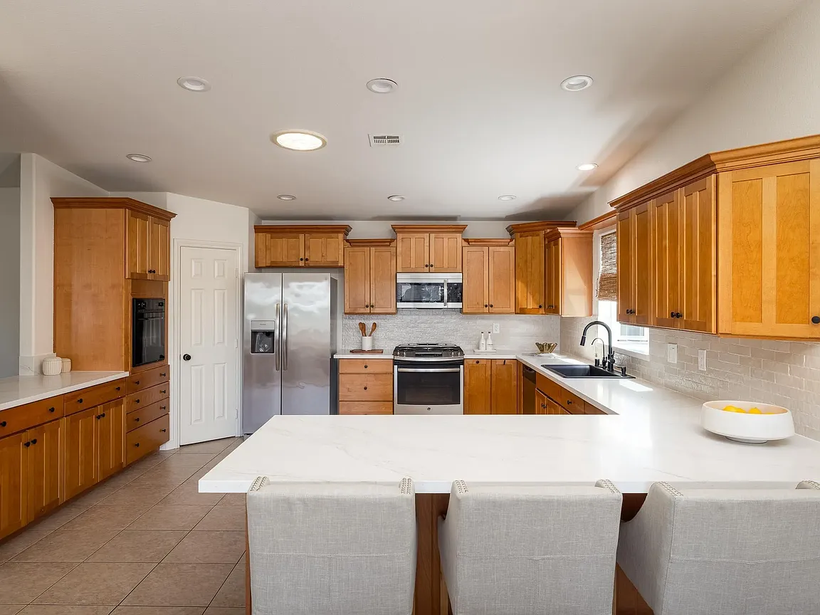 Full kitchen with stainless appliances and quartz island