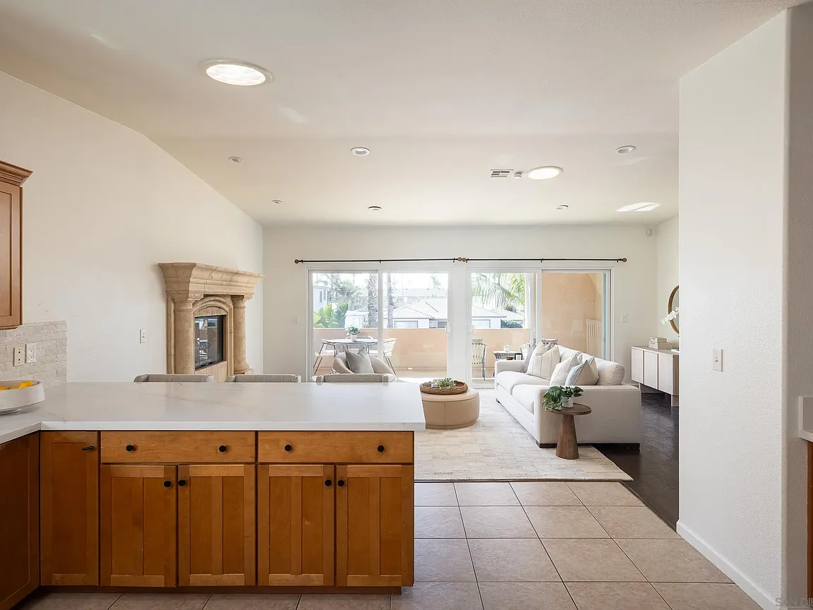 Kitchen island opening to the living room and balcony