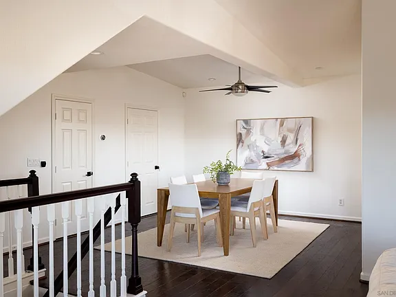 Dining area with vaulted ceiling and artwork