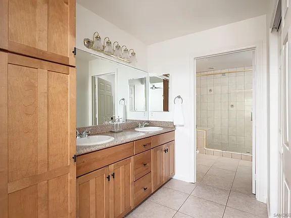 En-suite bathroom with dual vanities and walk-in shower