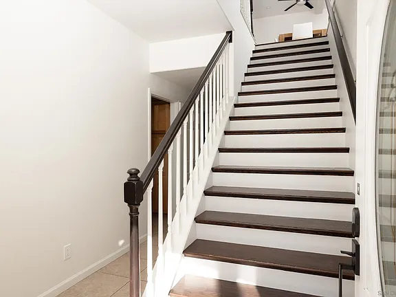 Stairwell with hardwood treads connecting both levels
