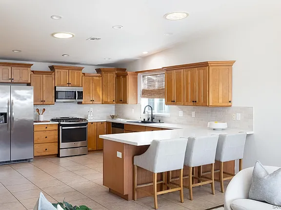 Kitchen with new countertops and breakfast bar
