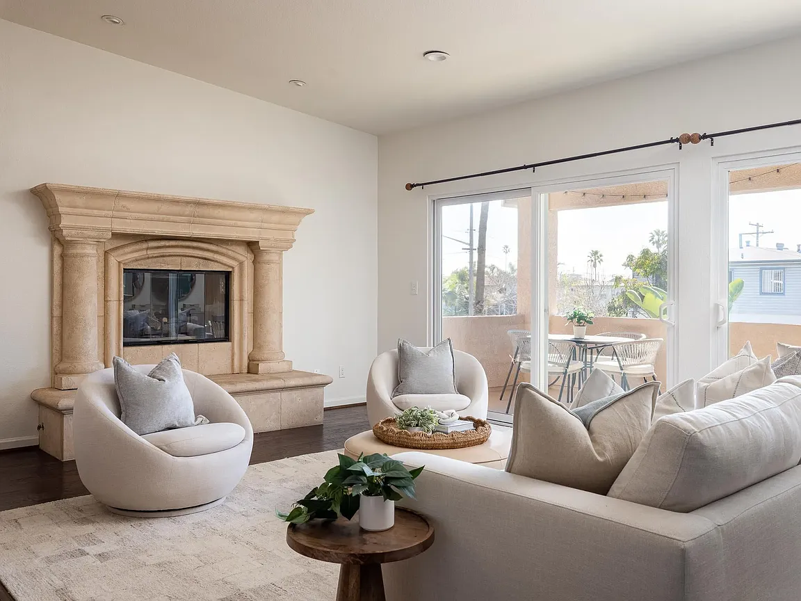 Living room with fireplace and balcony beyond